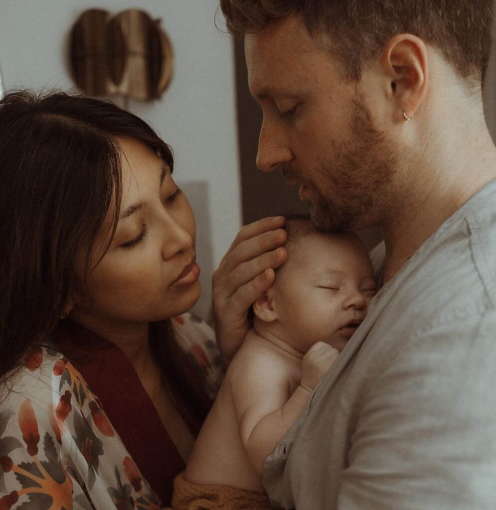 Intimate Family Moment With Newborn At Home