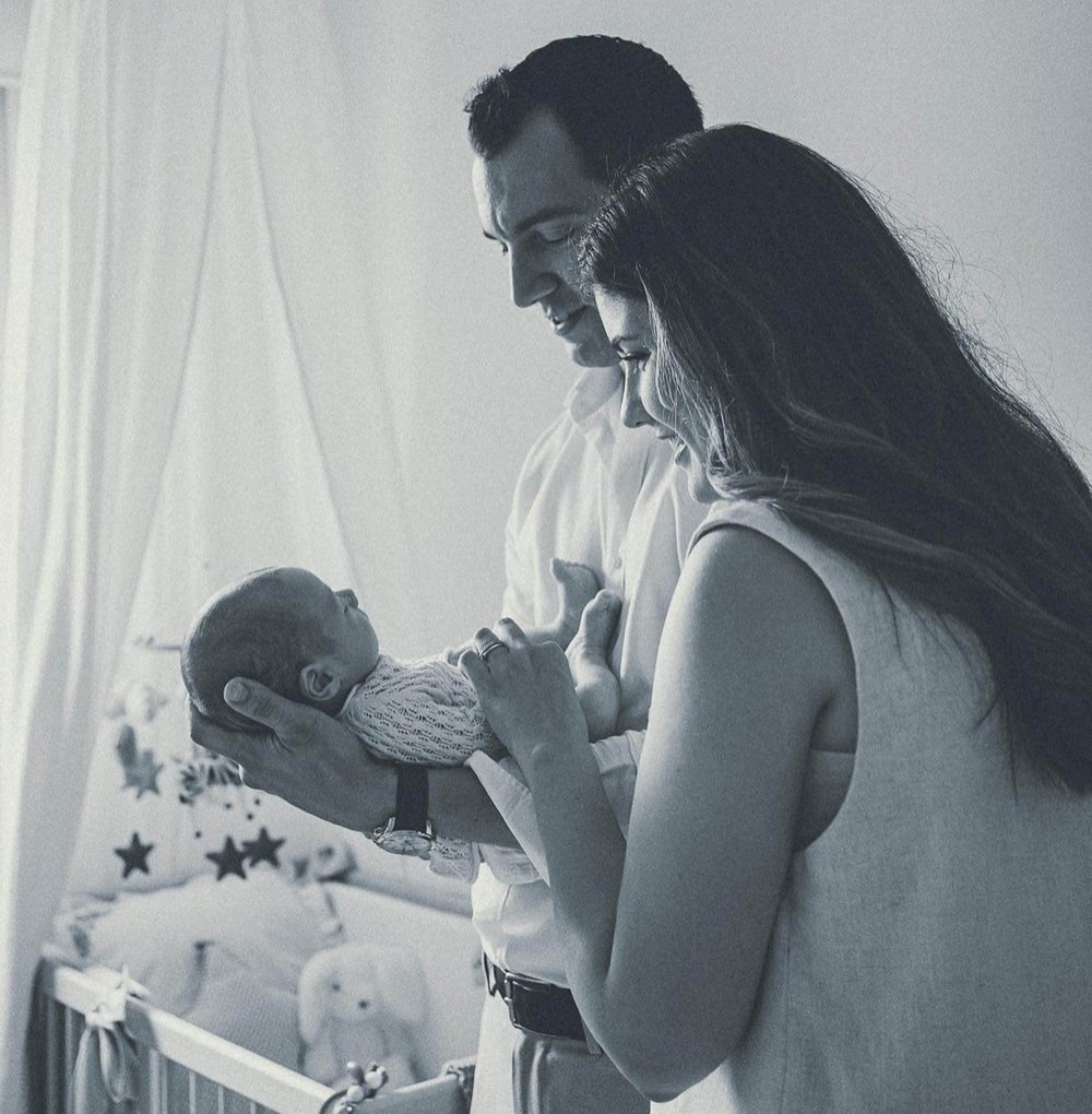 Newborn With Parents In Home Nursery