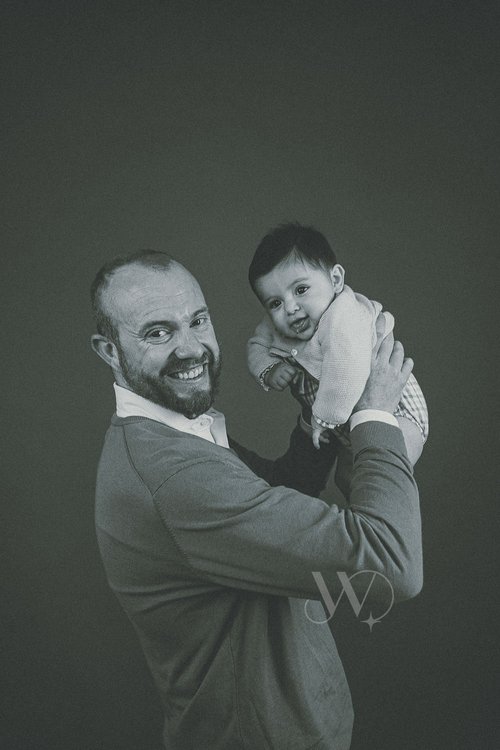 Father Holding Baby With Joy Family Portrait