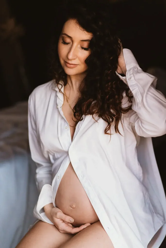 Expectant mother in a serene maternity photo shoot.