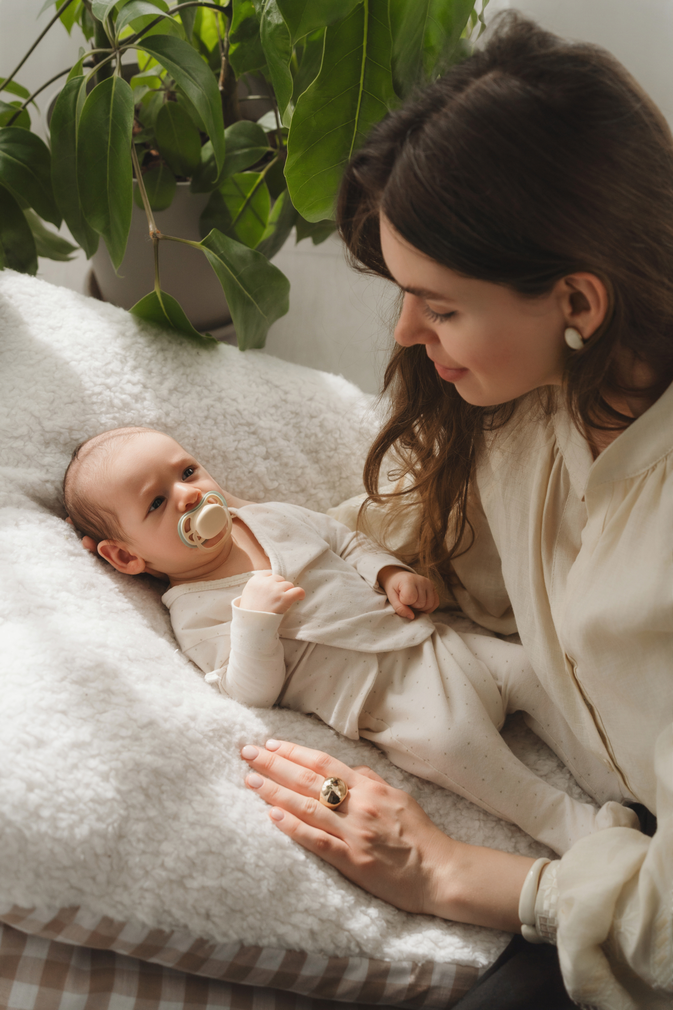 mom baby pacifier bed newborn photos at home