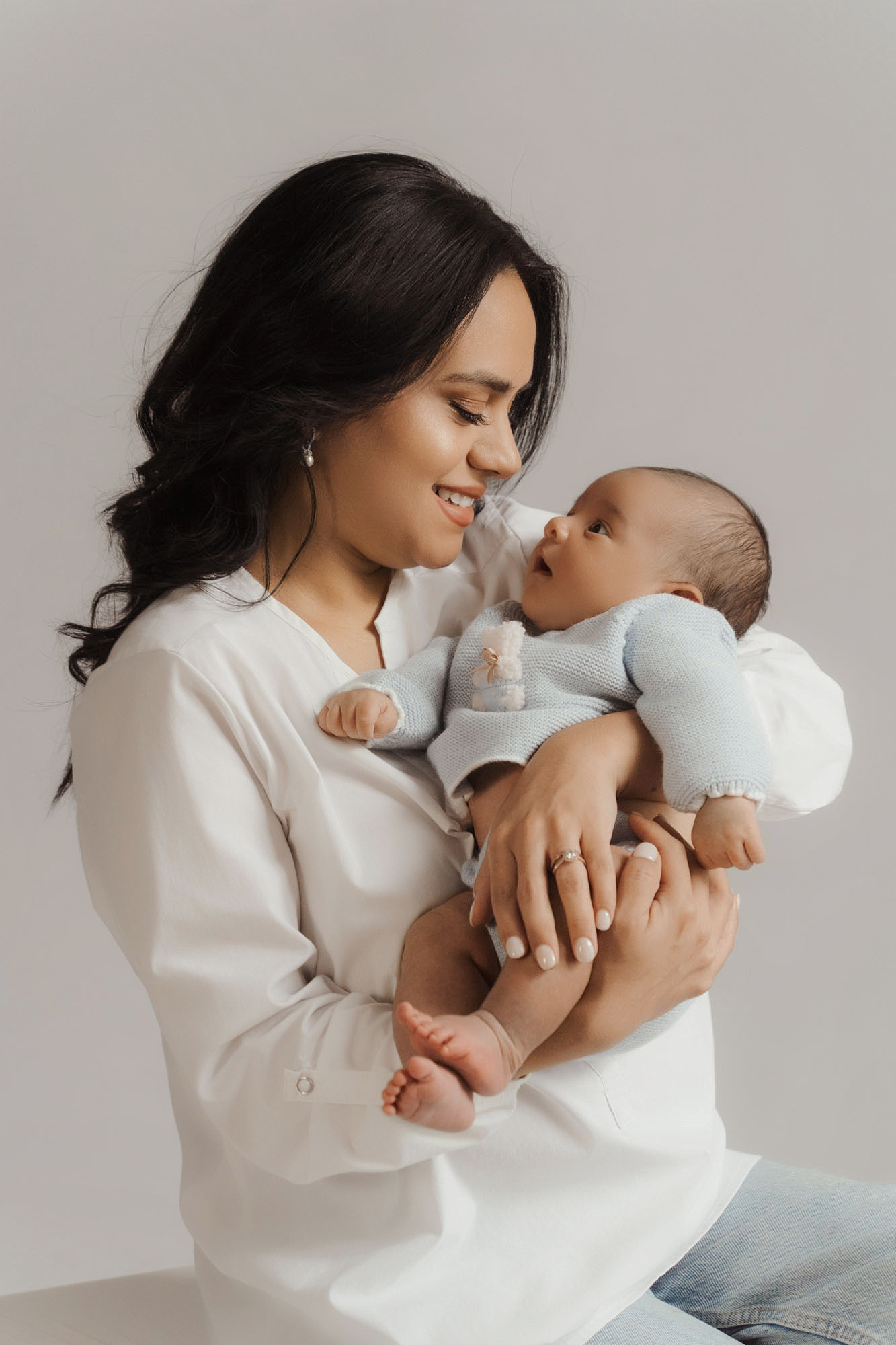 mom holding baby arms newborn photo at home connection