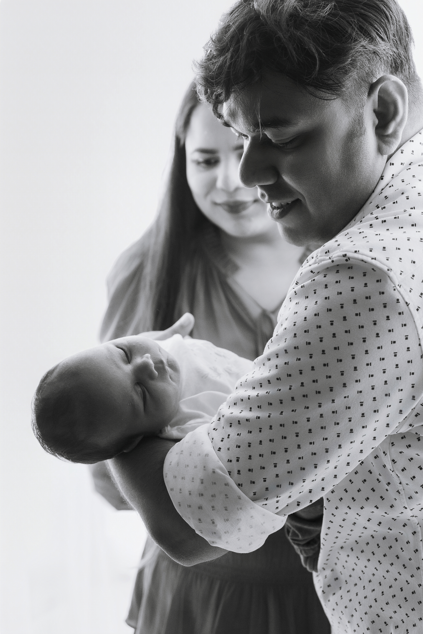 father holding baby arms newborn photos home natural light