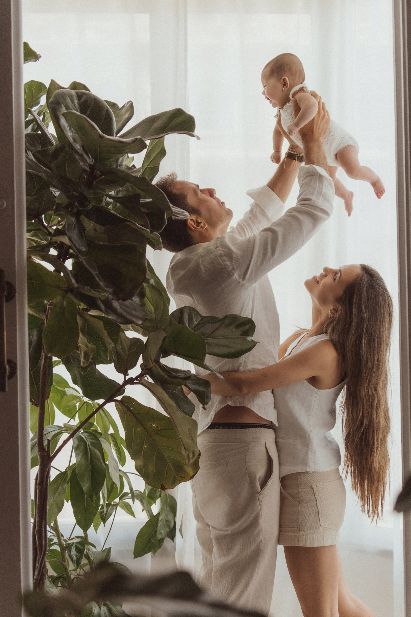 dad lifting baby family newborn photos at home