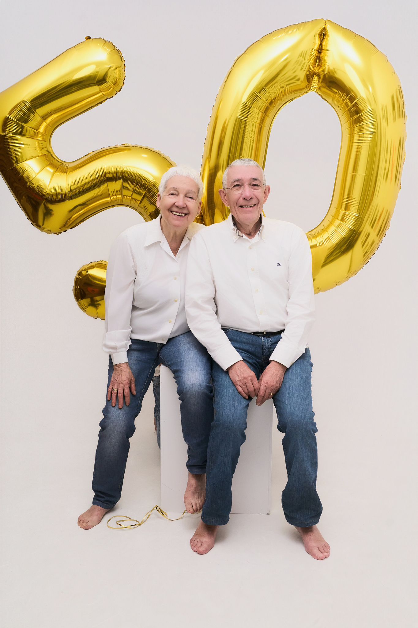 couple sixty years golden balloons birthday photoshoot