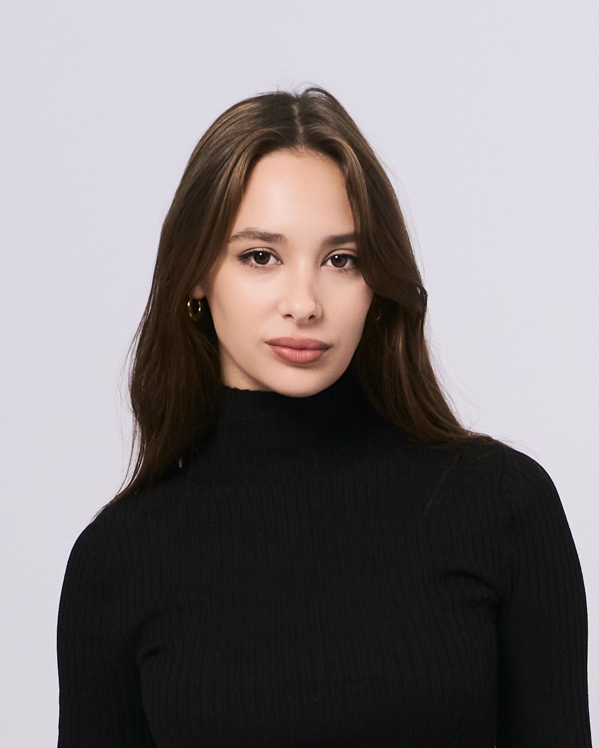 Woman in black sweater with professional CV photo against grey background