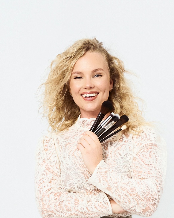 Woman smiling in professional CV photo on white background