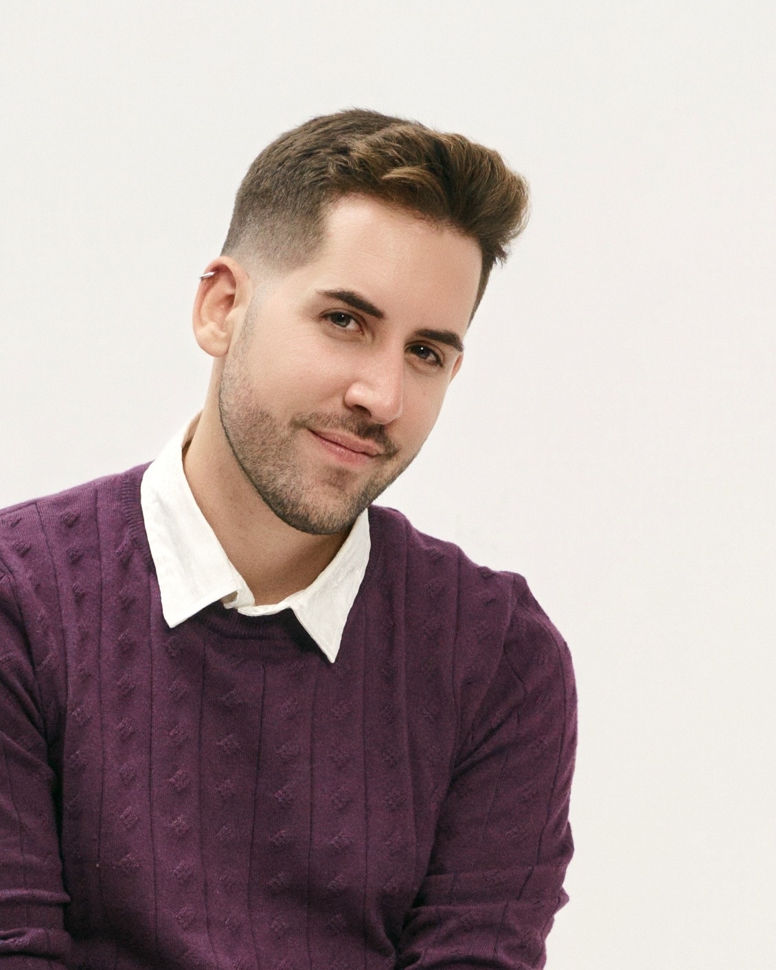 Man in burgundy sweater, professional headshot on white background