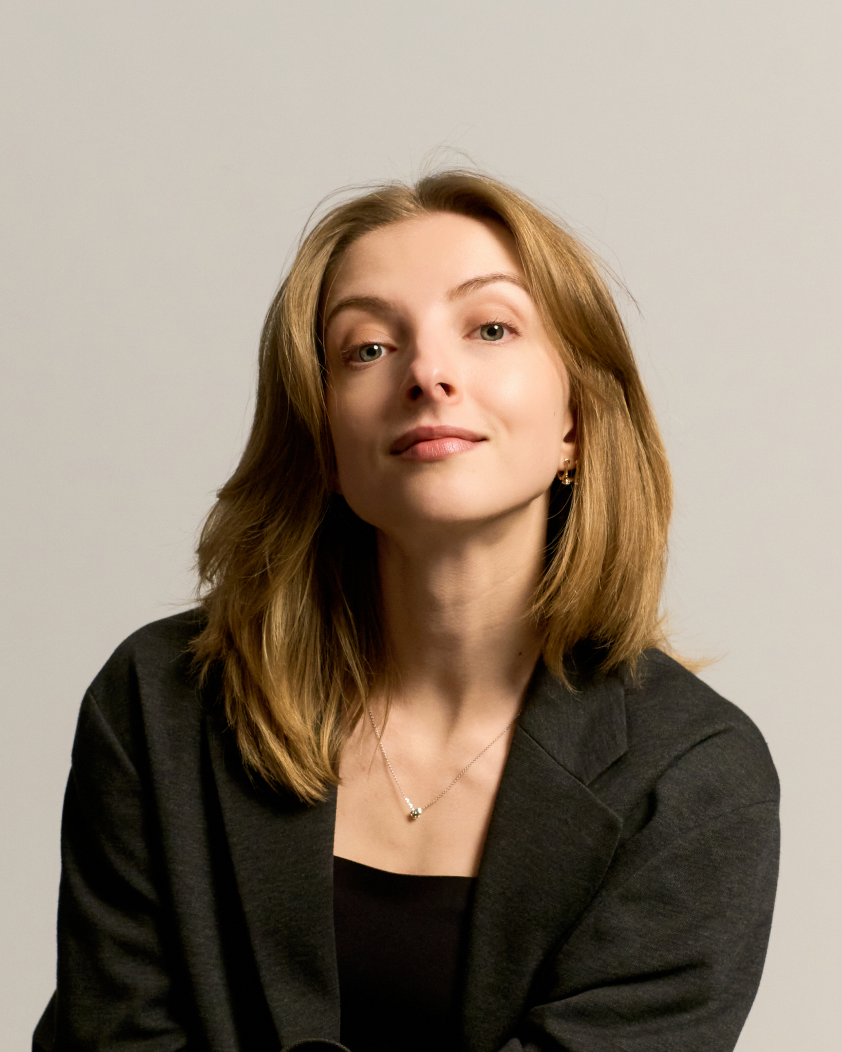 Woman in grey blazer at professional photo session in Barcelona studio
