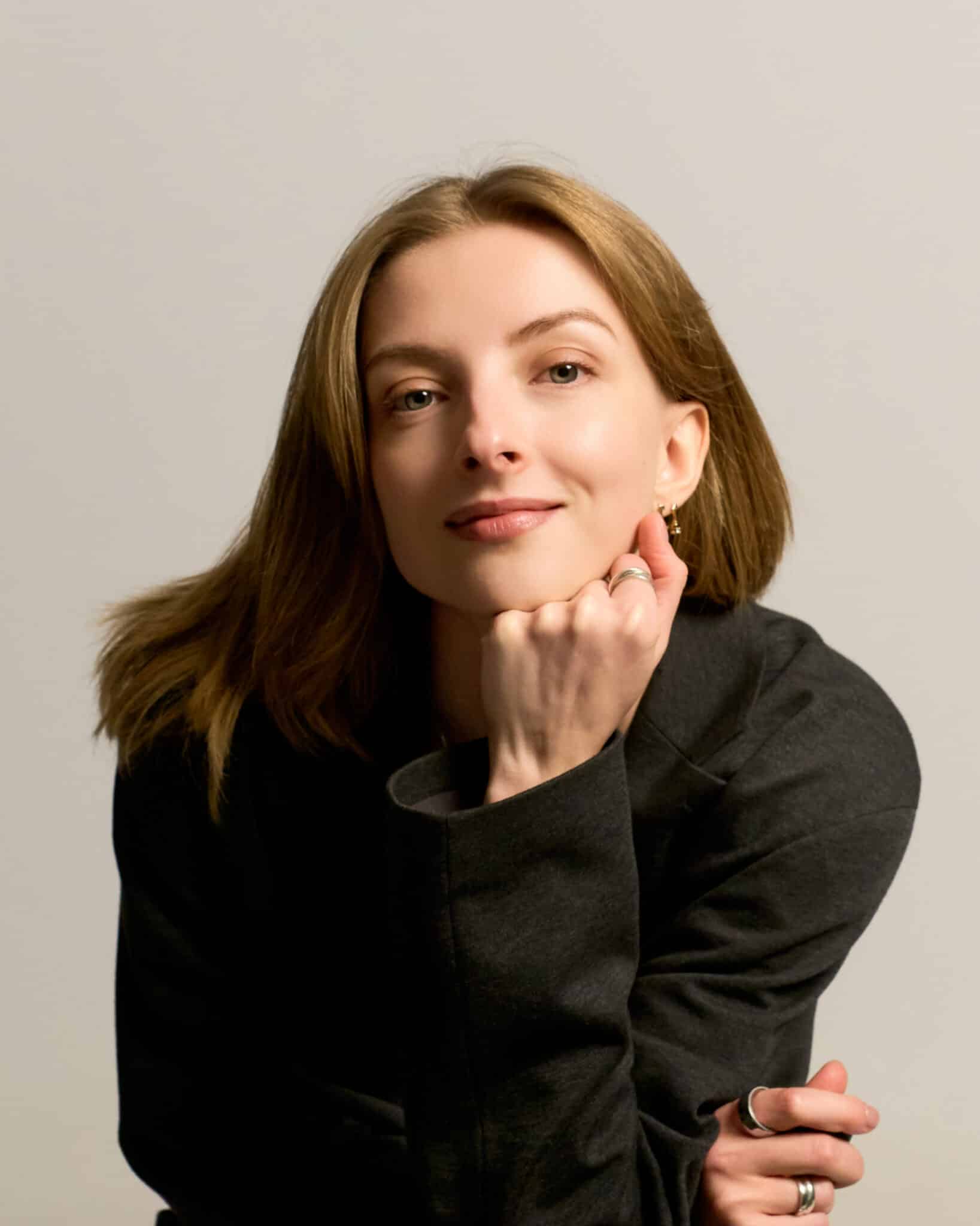 Woman in black top posing naturally for professional studio photo in Barcelona