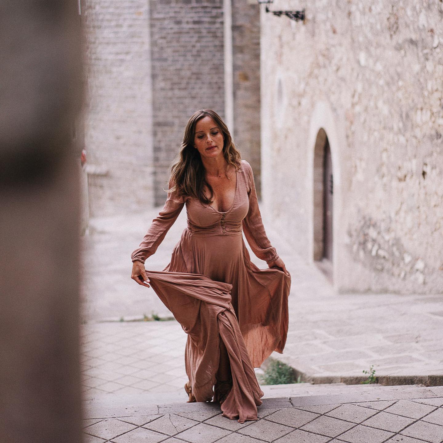 Pregnant woman in a long dress at the Pedralbes Monastery in Barcelona