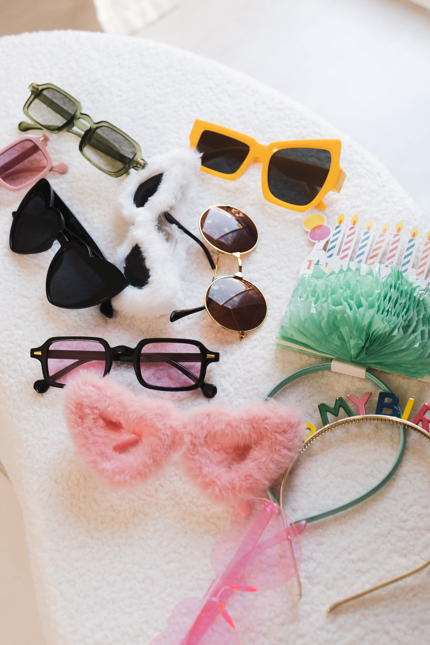Birthday party accessories flatlay — confetti, candles, party hats — Barcelona