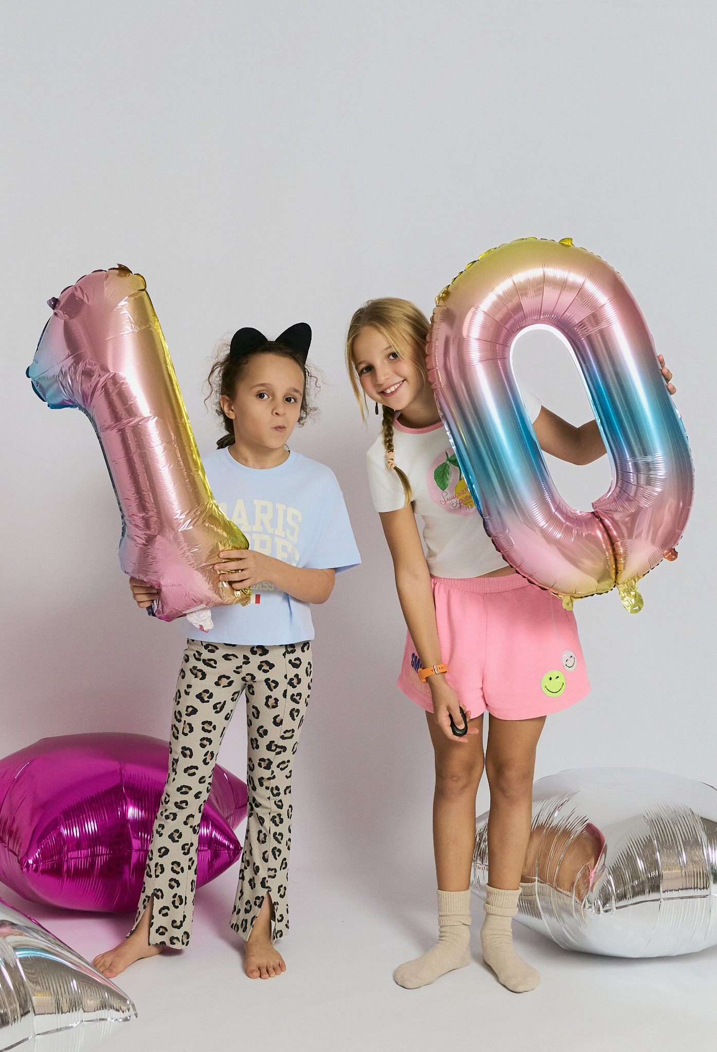 Ten-year-old daughter and her friend holding number-10 balloons at her birthday at YOULO Barcelona