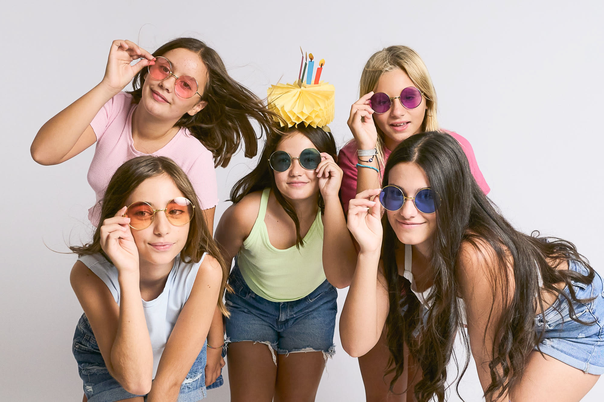 Five teens in sunglasses celebrating a birthday at a Barcelona photo studio